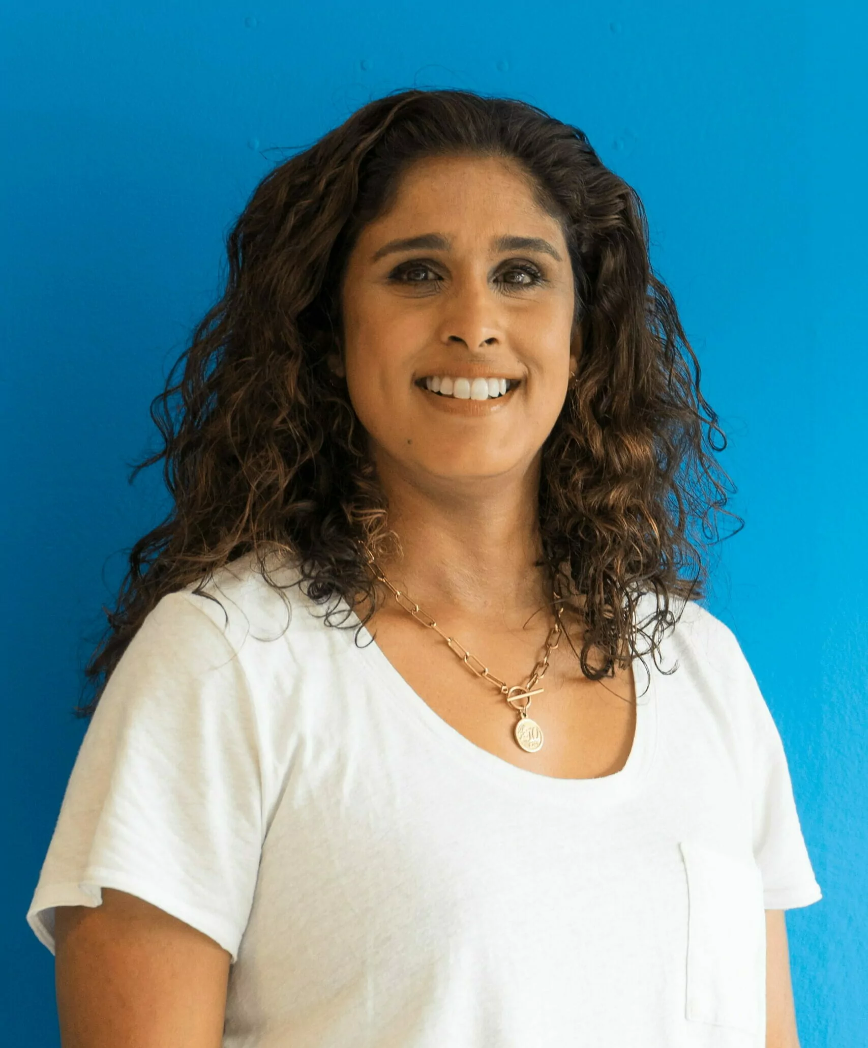 Adrianna stood against a blue background