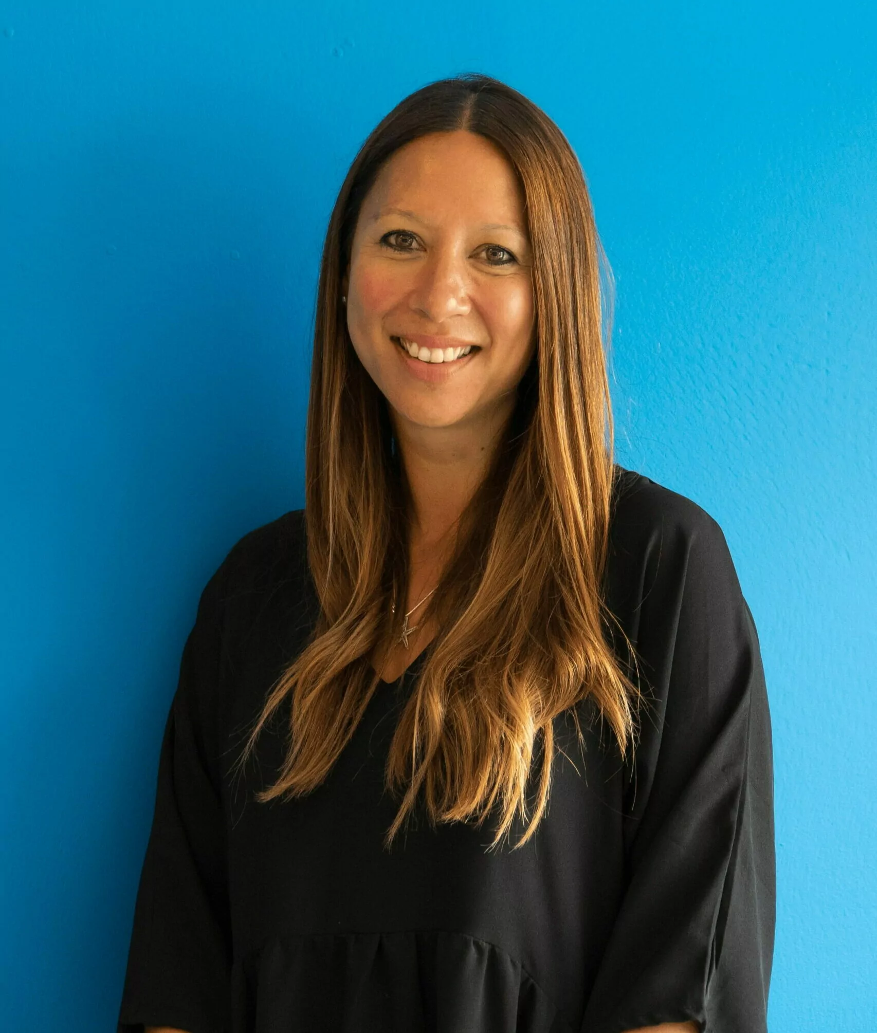 Holly stood infront of a blue background