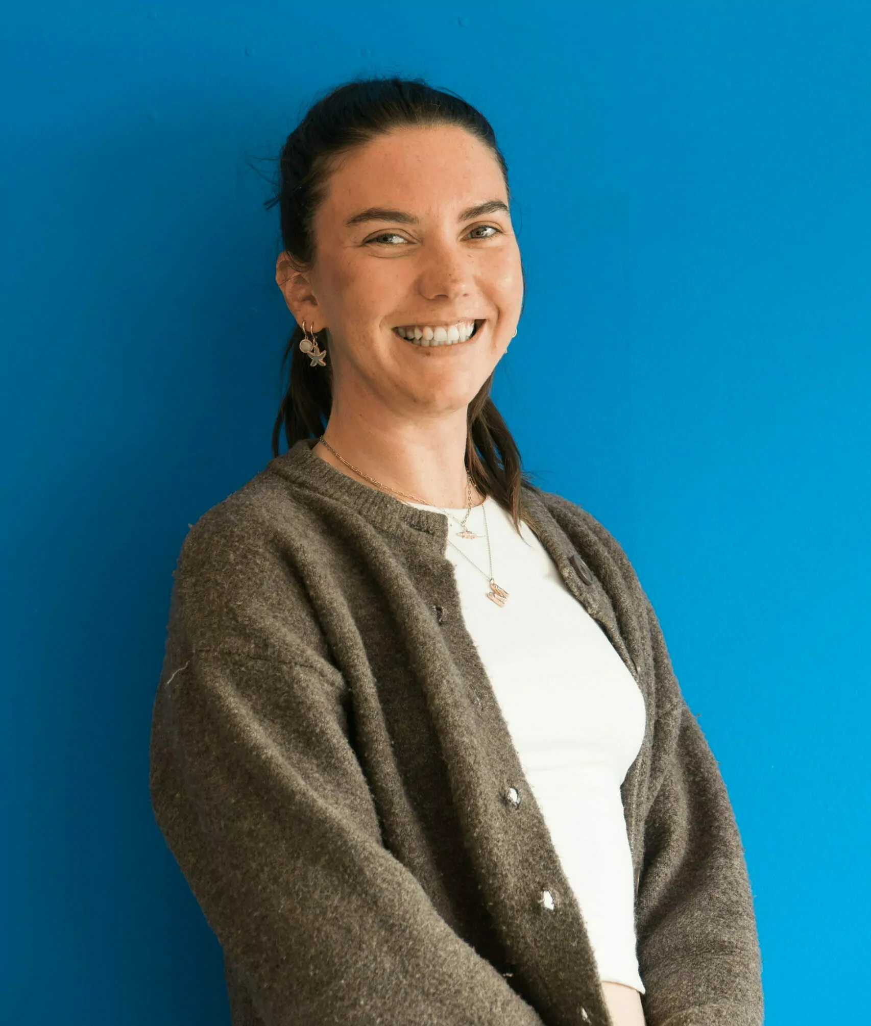 Megan stood infront of a blue background