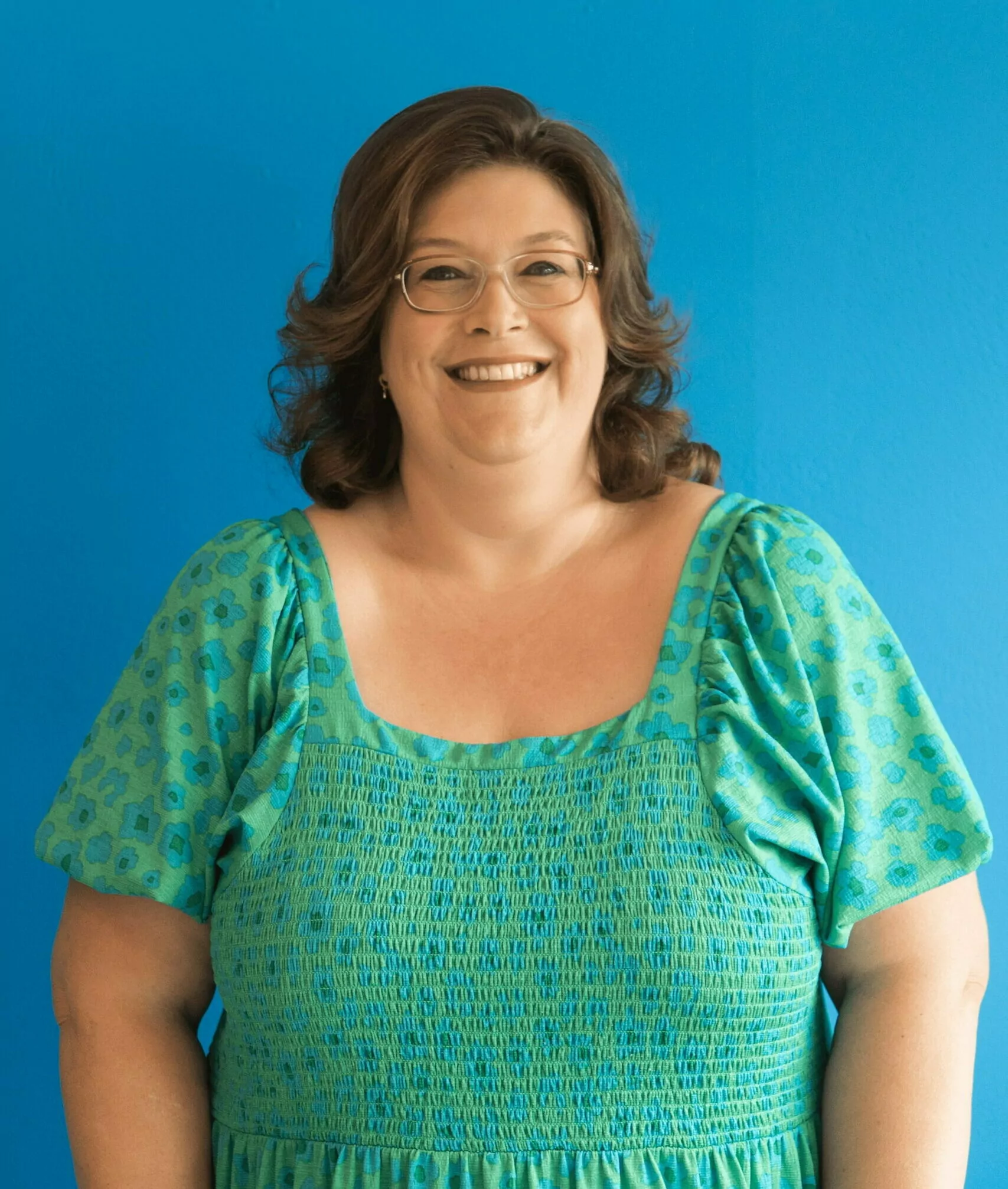 Nicola stood infront of a blue background