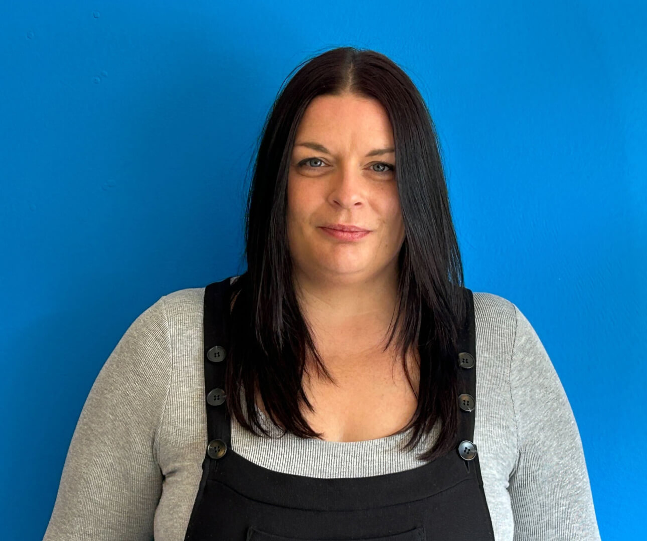 Image of new Account Director, Lauren on blue background.