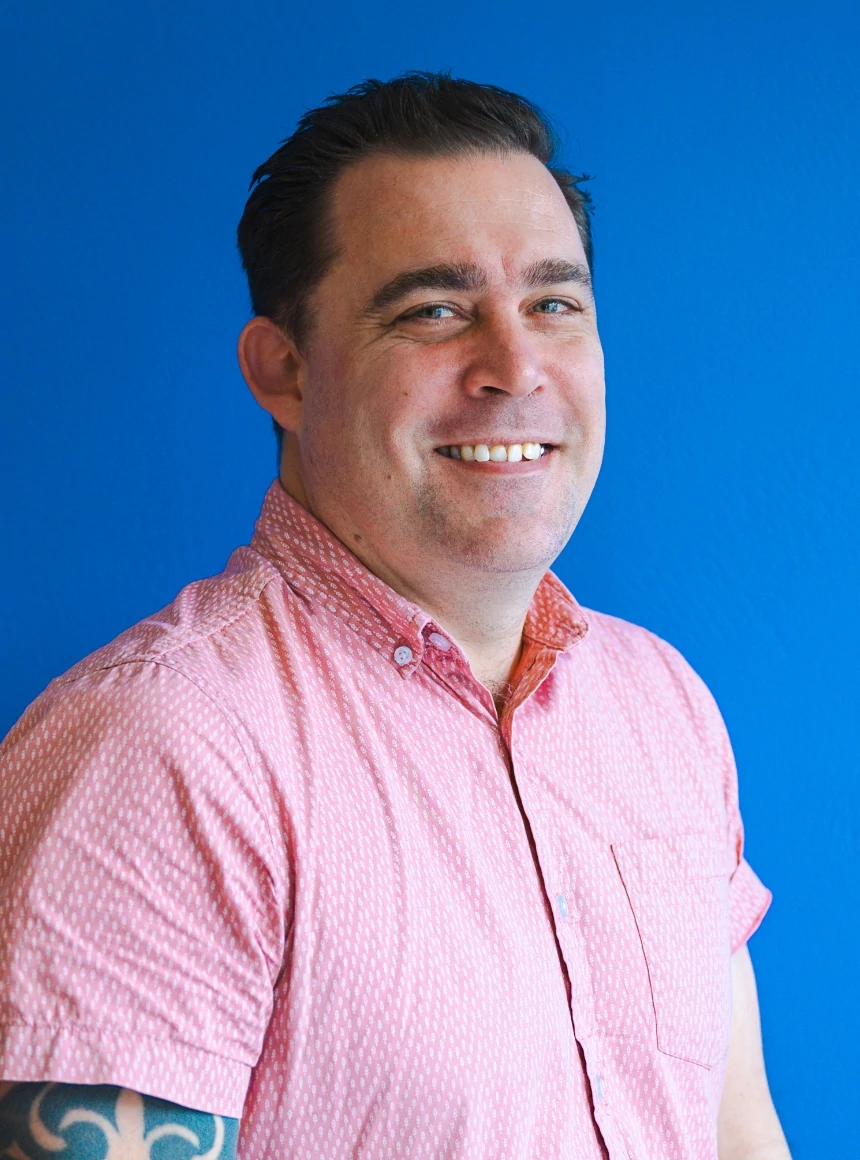 Nick Bain on a blue background.