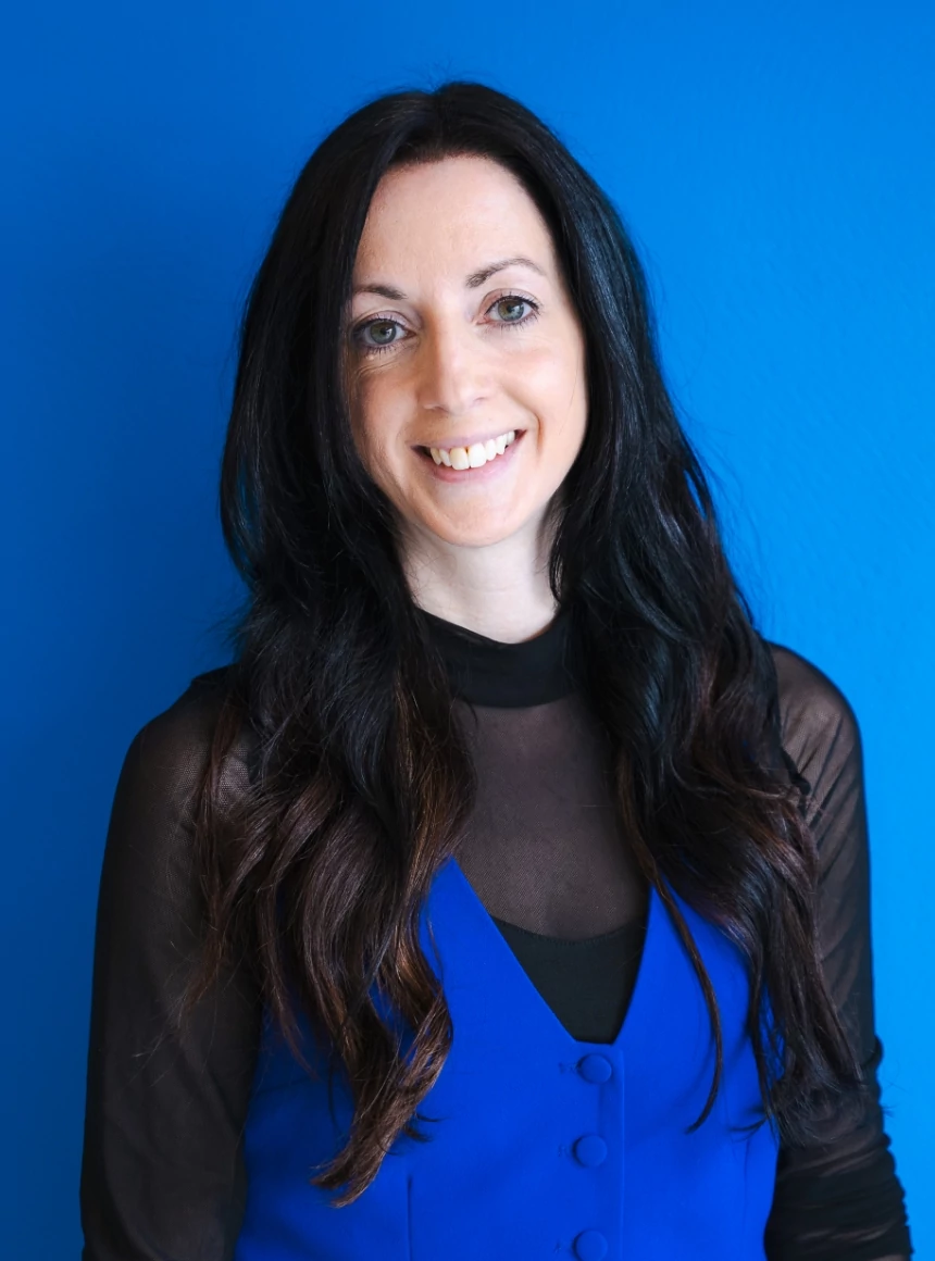 Carly Vrettos on a blue background.