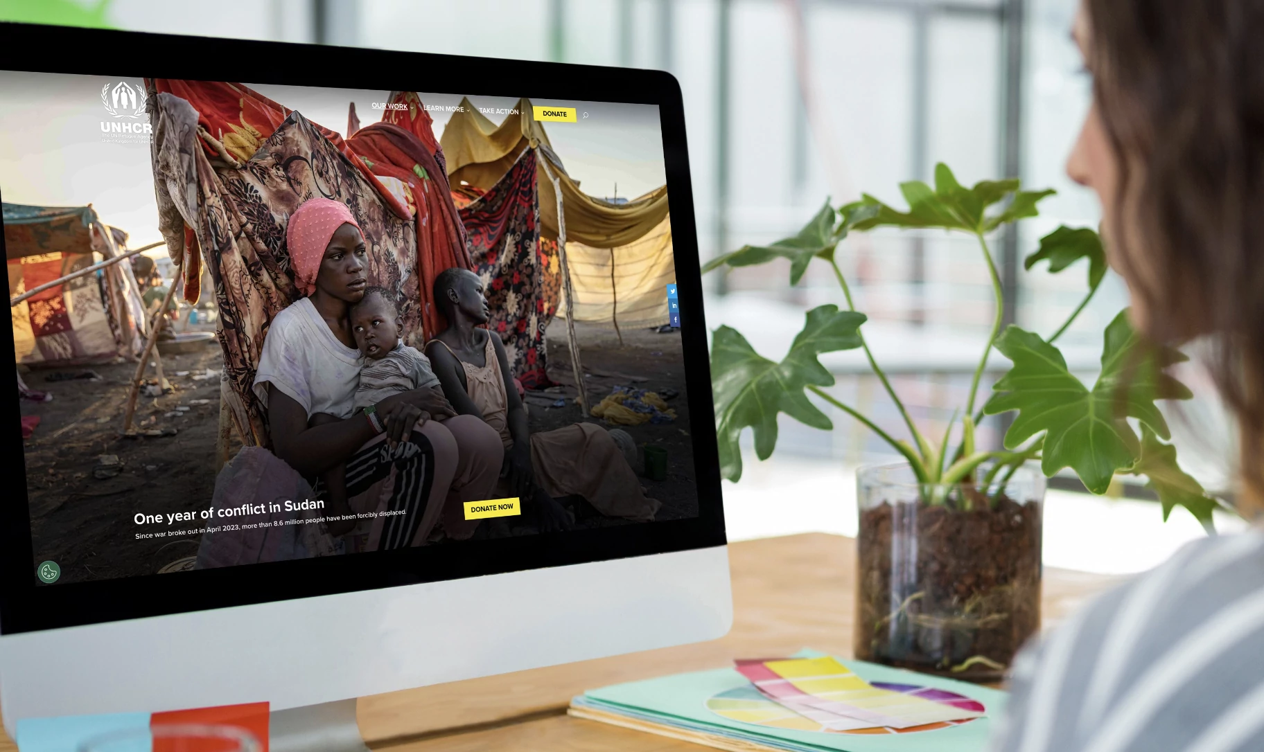 UNHCR website showing a mother and child in a refugee camp with a banner about one year of conflict in Sudan and the ongoing humanitarian crisis.